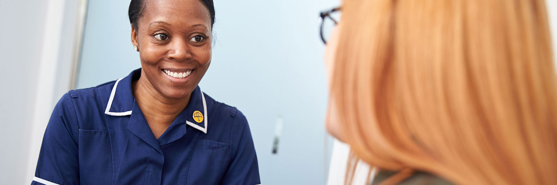 Umbrella nurse talking to a patient